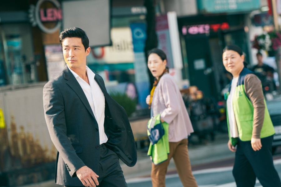 Daniel Henney as Kim Gae, standing in a dimly lit scene from Netflix K-drama ‘Genie, Make a Wish’ (2025) — wearing a dark costume, showing a serious expression during his cameo appearance.