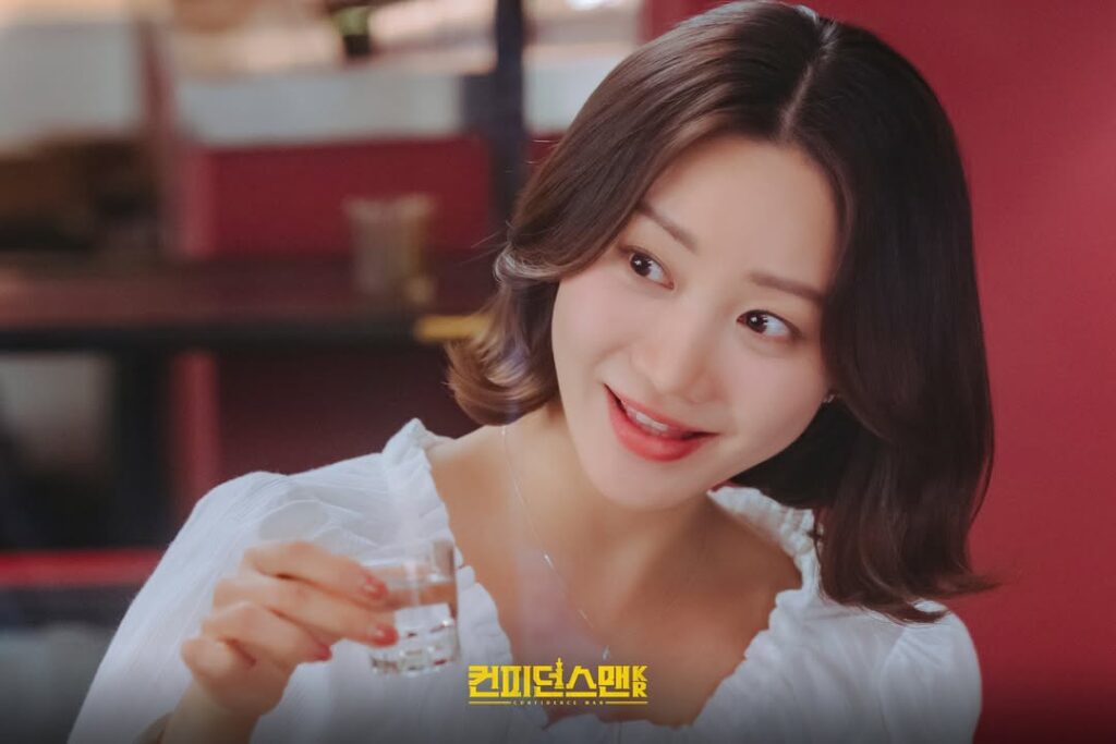 Han Groo as Go Sang hee in ‘Confidence Queen TV Chosun Drama Still Han Groo portraying Go Sang-hee, involved in a romantic storyline with James (Park Hee-soon), in TV Chosun’s ‘Confidence Queen’; scene highlights her expressive, understated performance.
