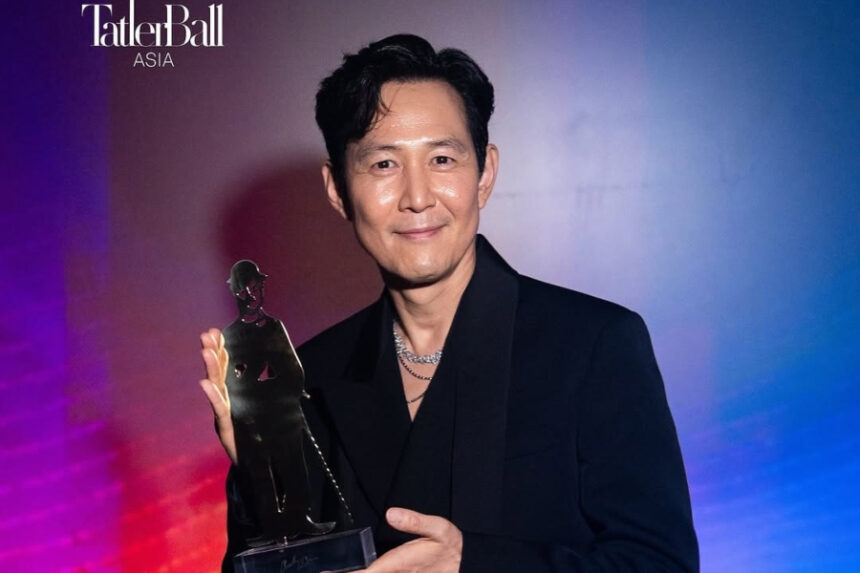 Lee Jung-jae, ‘Squid Game’ actor and Artist Company founder, holding the Charlie Chaplin Lifetime Achievement Award in Singapore ceremony 2025 — first Korean recipient, global film honor.